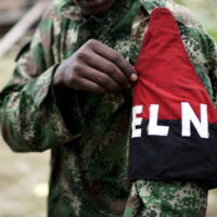 FILE PHOTO: A rebel of Colombia's Marxist National Liberation Army (ELN) shows his armband while posing for a photograph, in the northwestern jungles, Colombia August 31, 2017. REUTERS/Federico Rios/File Photo